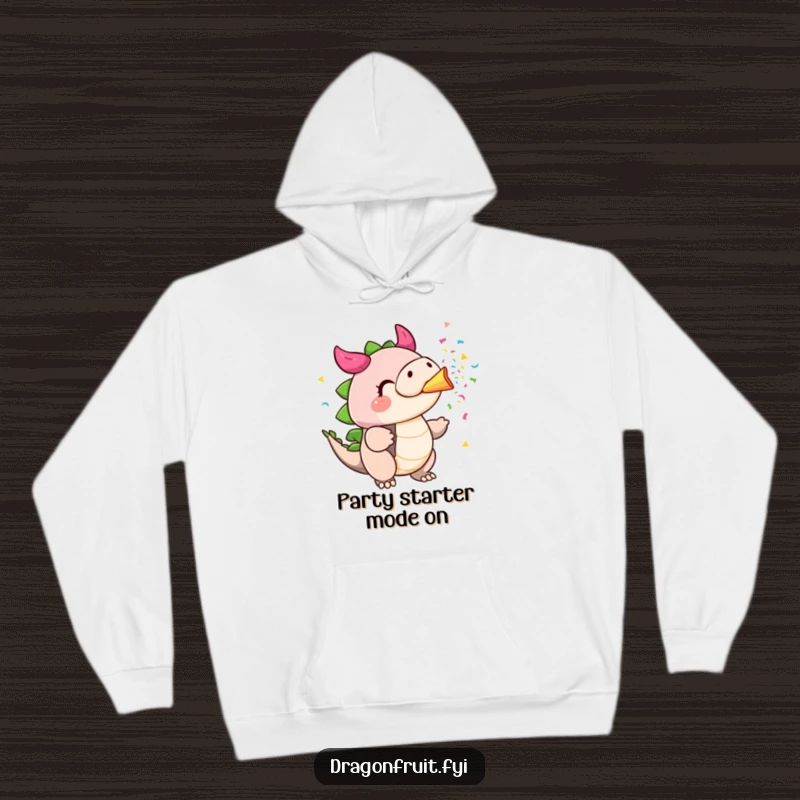 Funny dragonfruit hoodie, cheeks puffed, blowing colorful confetti from its stem like a party horn, cozy and festive.