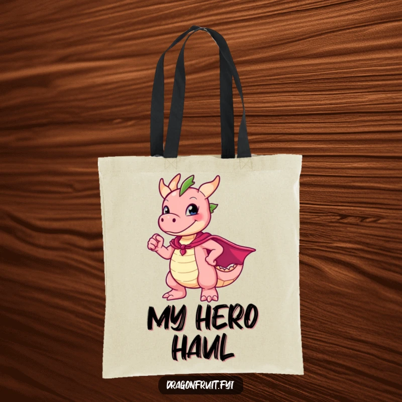 Funny Dragonfruit Tote Bag featuring a character in a superhero cape striking an awkward, endearing pose, great for carrying anything.
